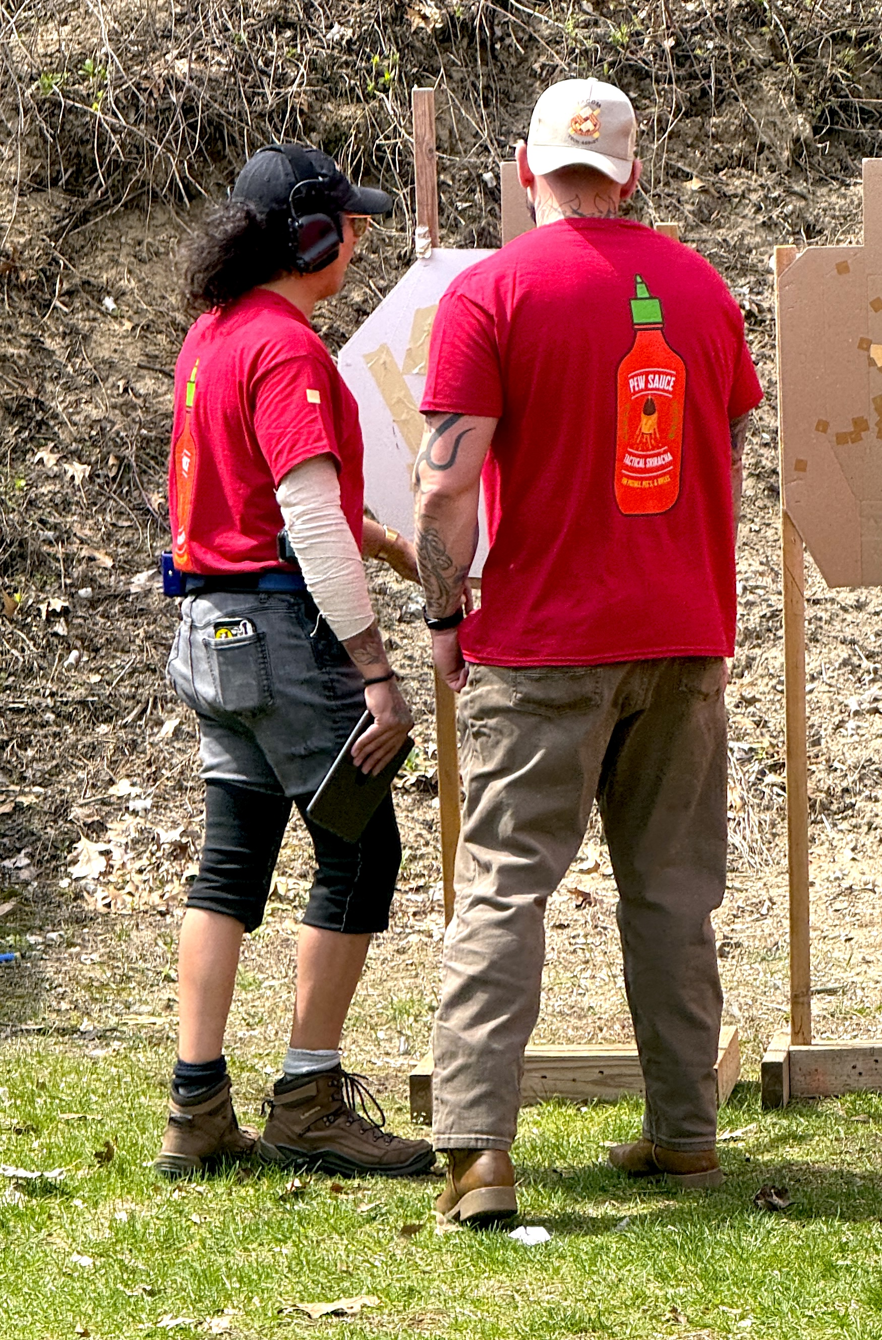 Two shooters reviewing targets at a range event